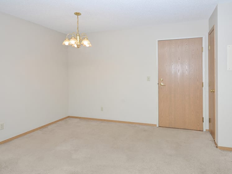 Carpeted Dining Room with Chandelier